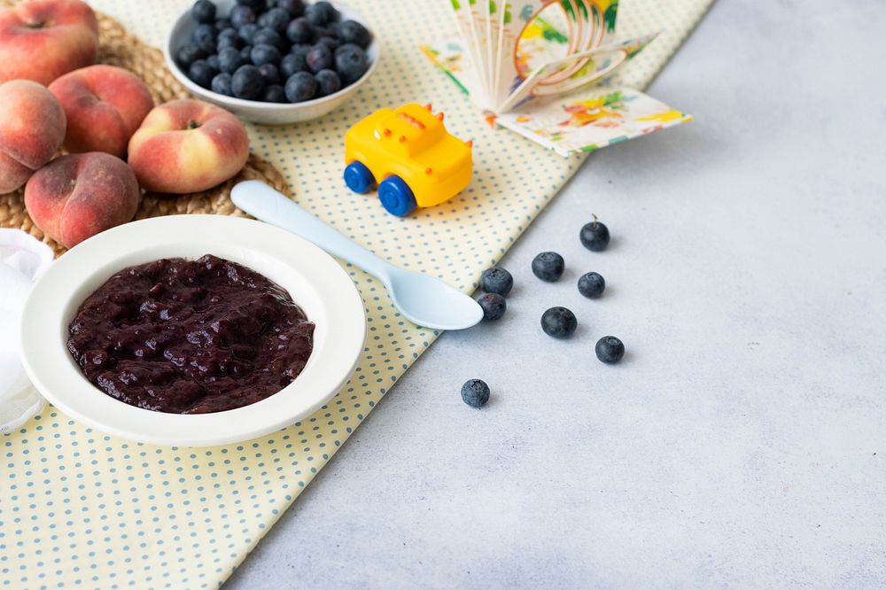 Baby food background, blueberry puree healthy recipe