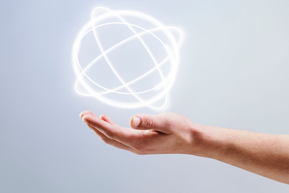 Atom hologram background showing on man&rsquo;s hand science technology remix