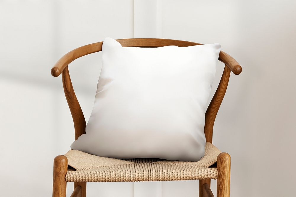 White cushion pillow on a chair with design space