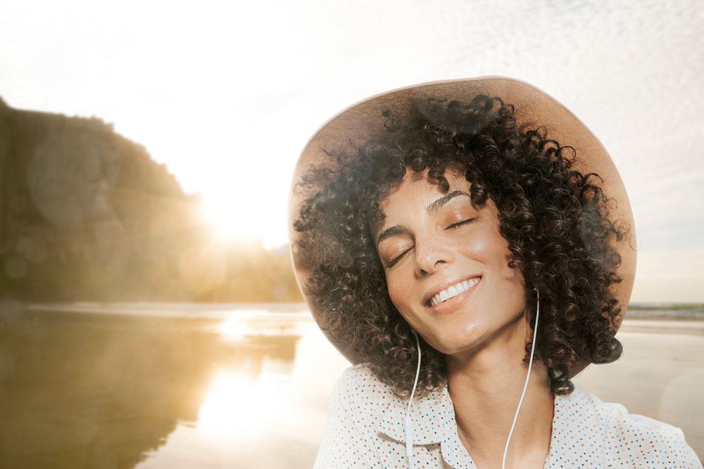 Woman wearing earphones with nature view remixed media