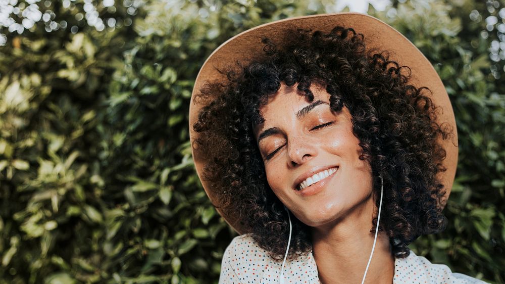 Woman with curly hair wearing earphones remixed media