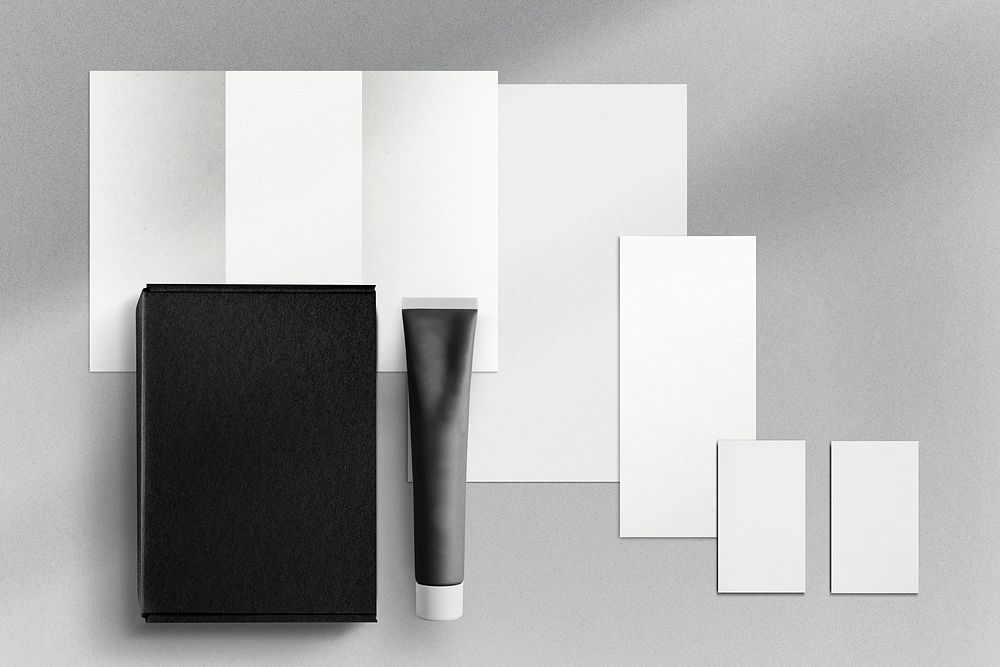 Stationery and tube on gray background