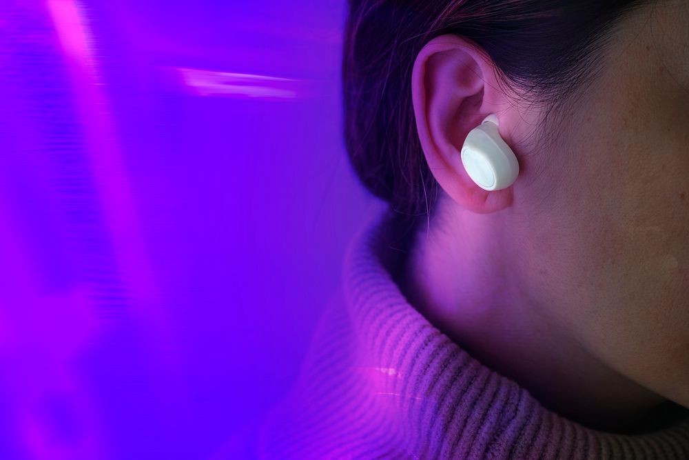 Purple technology background with woman in wireless earphone