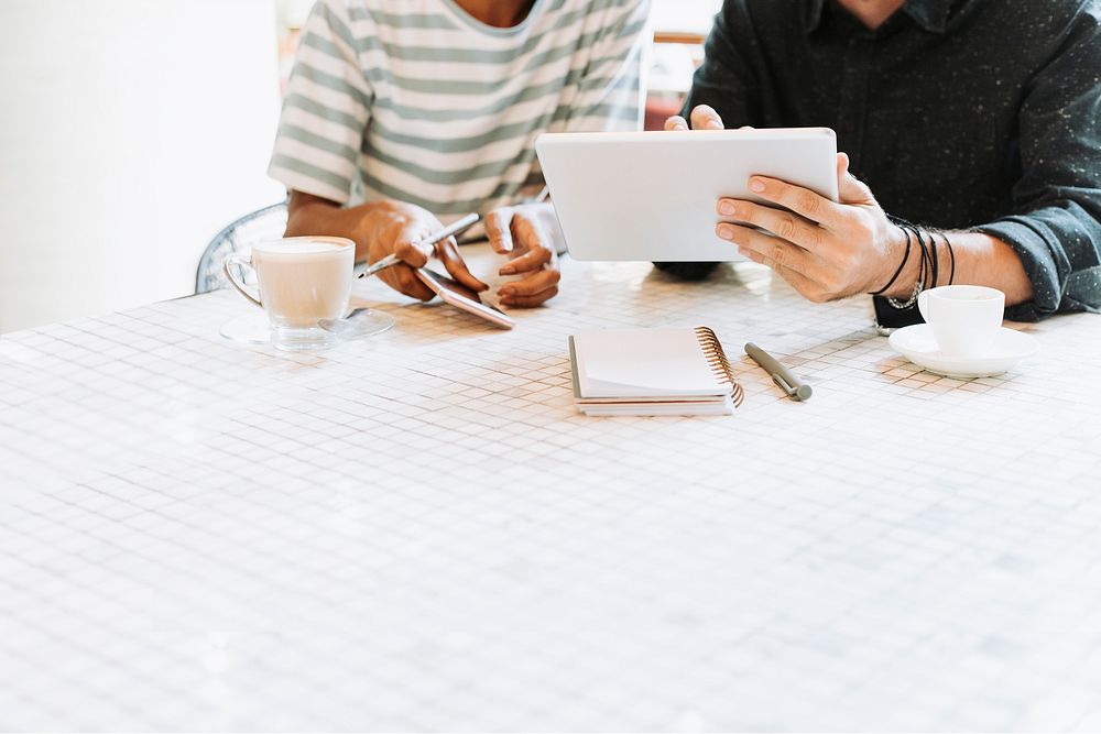 Colleagues discussing work on a table with design space