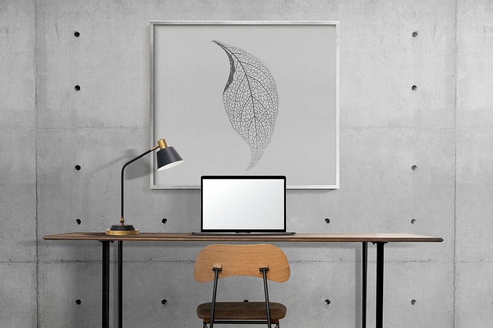 Industrial home office interior design with leaf picture frame hanging on a wall