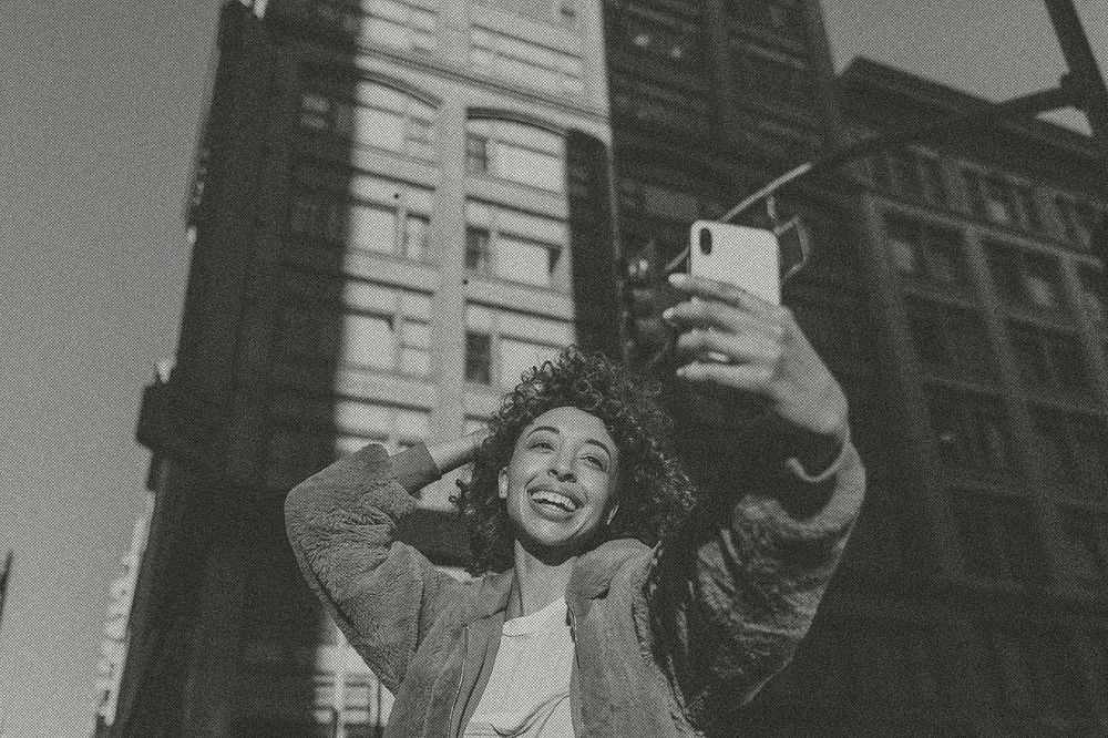 Woman taking selfie in city in black and white tone