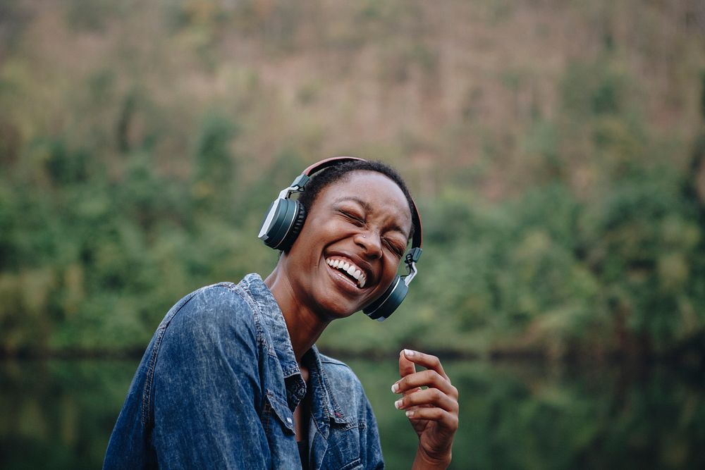 Woman listening to music outdoors, vivid tone filter