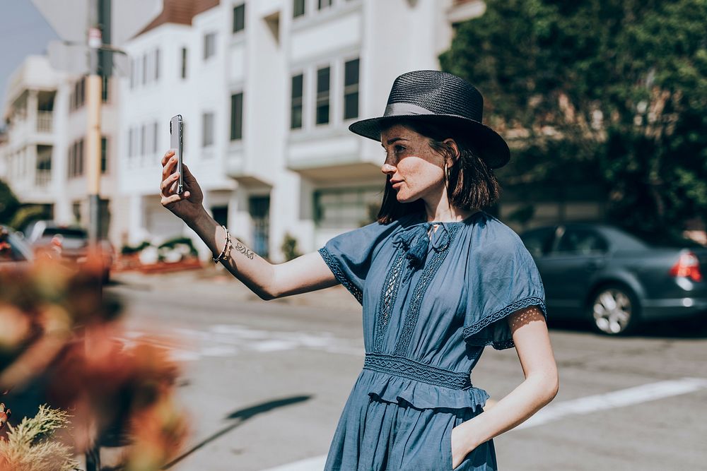 Woman taking selfie in a city, vivid tone filter