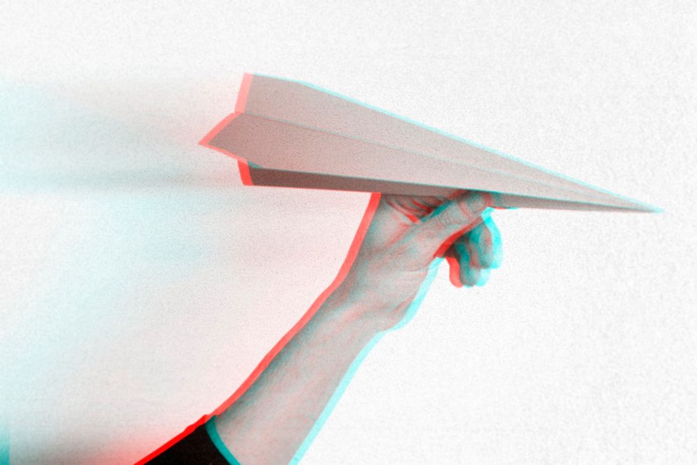 Anaglyph effect on hand holding paper plane