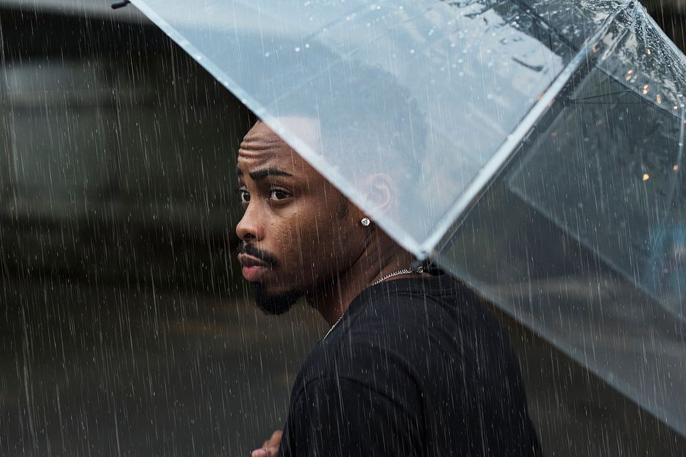 Man using umbrella on a rainy day