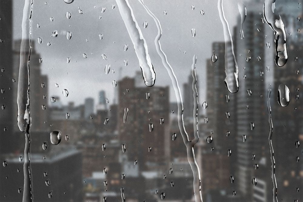 City view through window with rain drops
