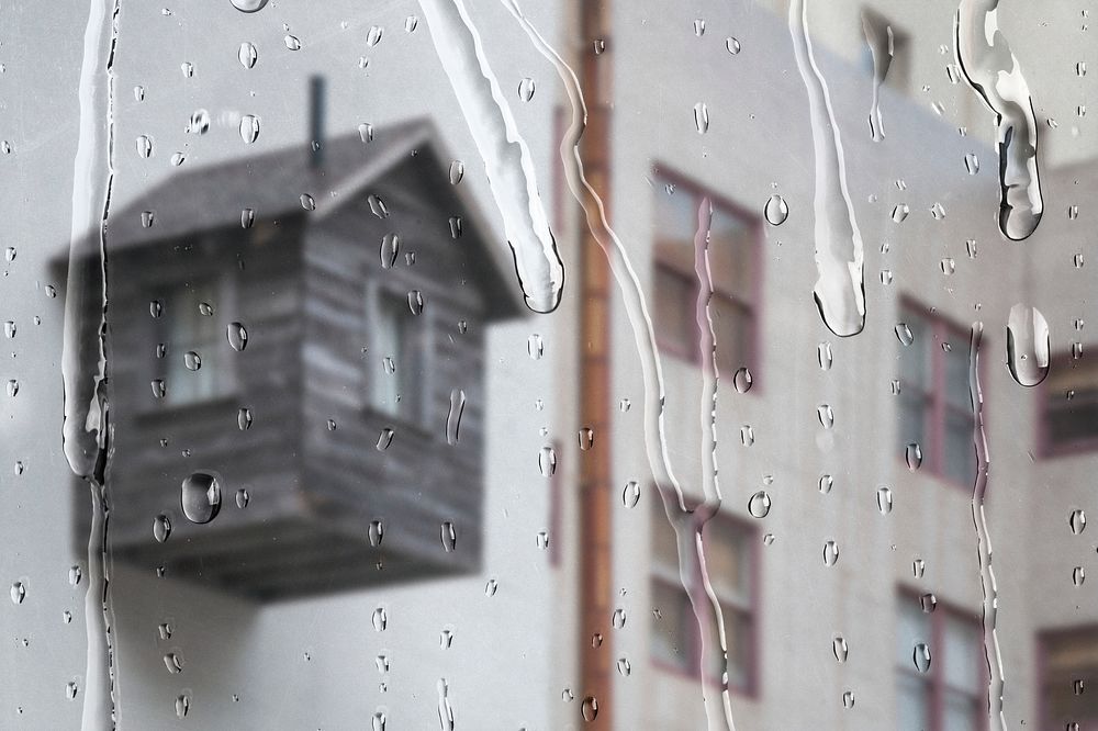 White apartment through window with rain drops