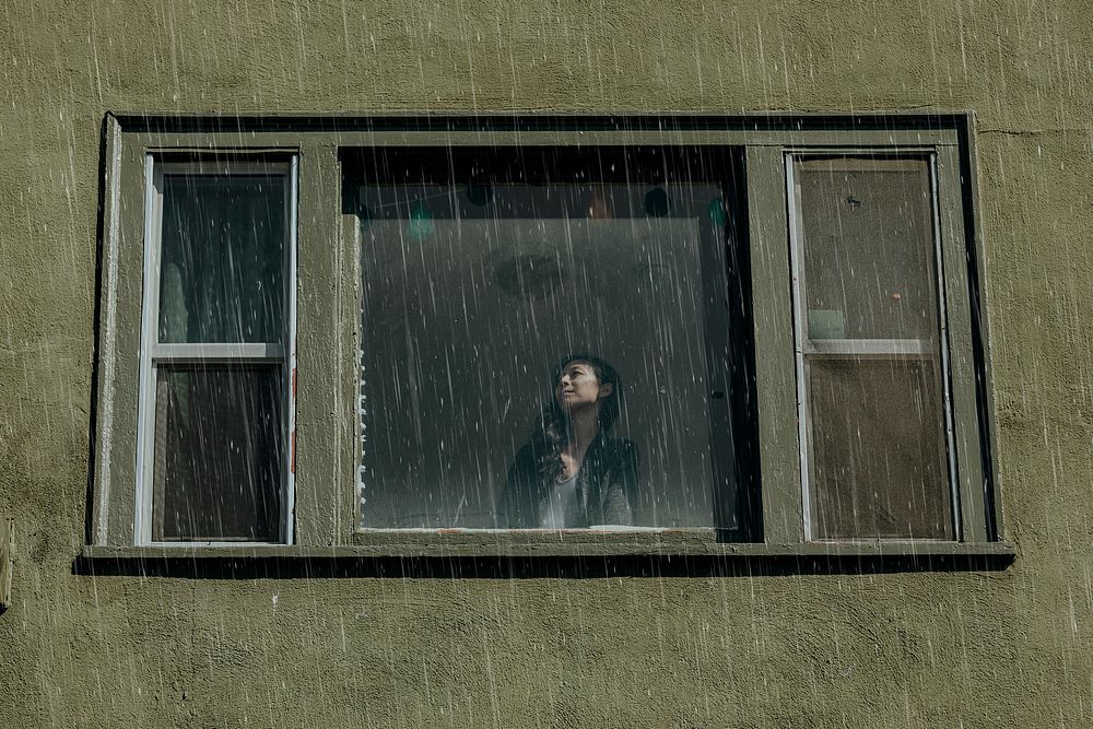 Woman in a house on a rainy day