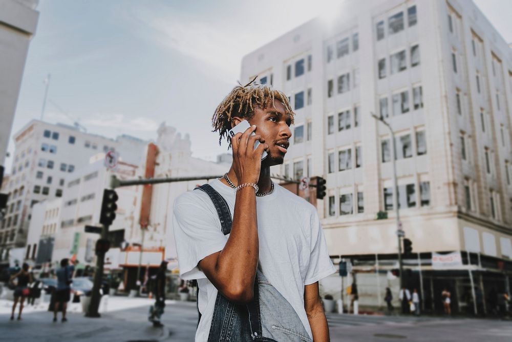 African American man chatting on a phone in the city