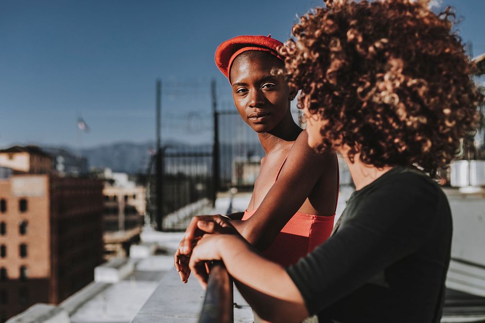 Women hanging out at rooftop balcony in the city