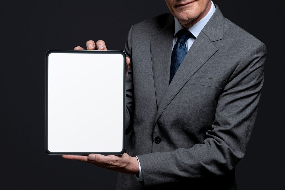 Businessman holding blank tablet with design space