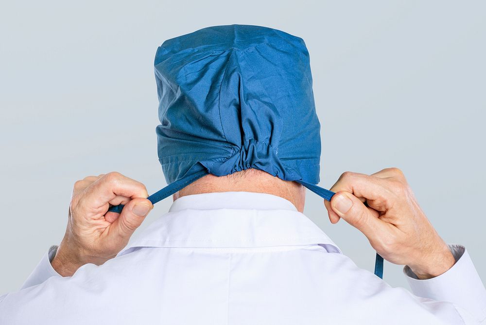 Male surgeon wearing a blue surgical cap
