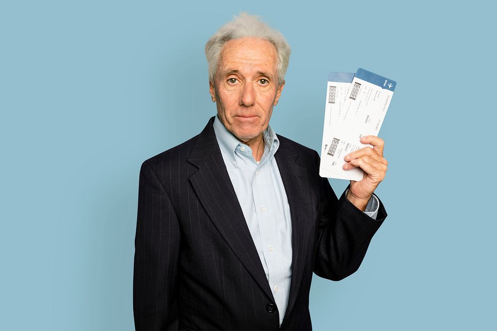 Senior man mockup psd in holding plane tickets for business trip