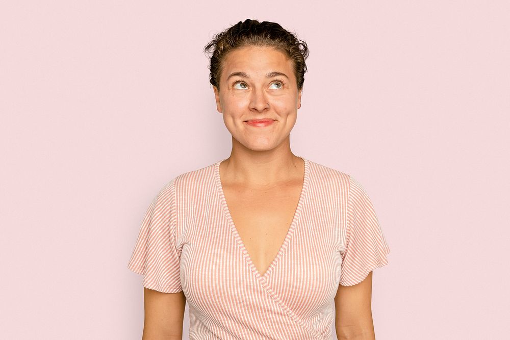 Brunette woman smiling on pink background