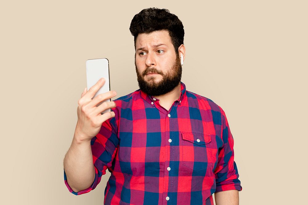 Bearded man streaming music with smartphone digital device