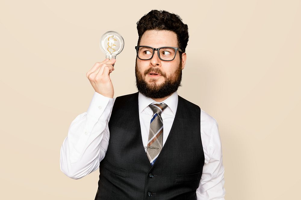 Bearded businessman holding a light bulb for innovation campaign