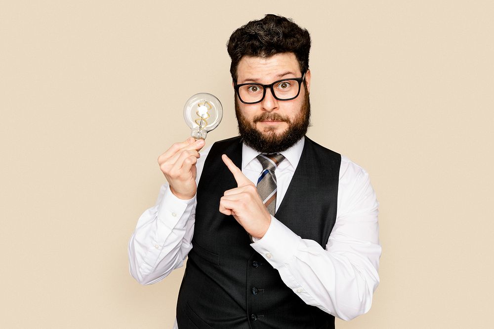 Bearded businessman holding a light bulb for innovation campaign