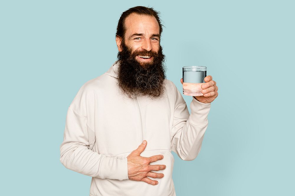 Healthy bearded man holding water glass