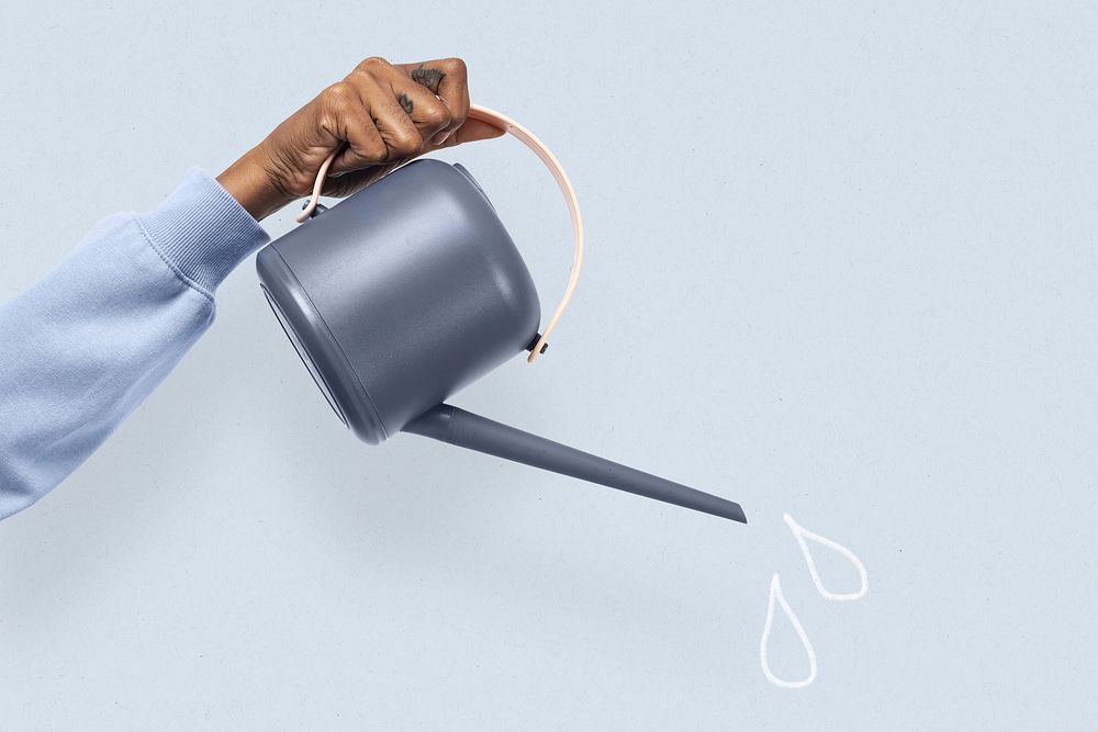 Hand mockup psd holding gray watering can gardening tool