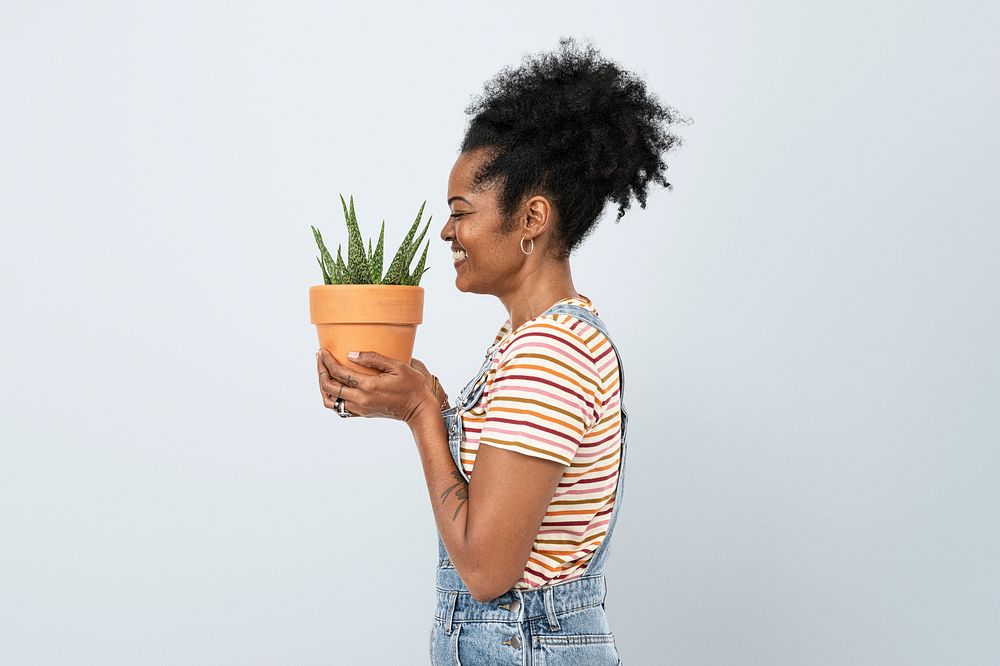 Woman holding a potted aloe vera succulent