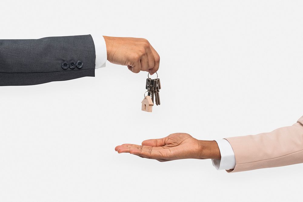 Hand giving key  real estate agent