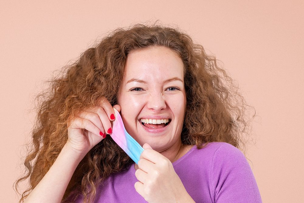 Woman taking mask off mockup during the new normal