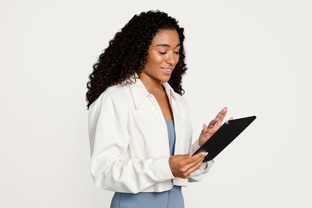 Woman working on digital tablet, isolated on off white psd