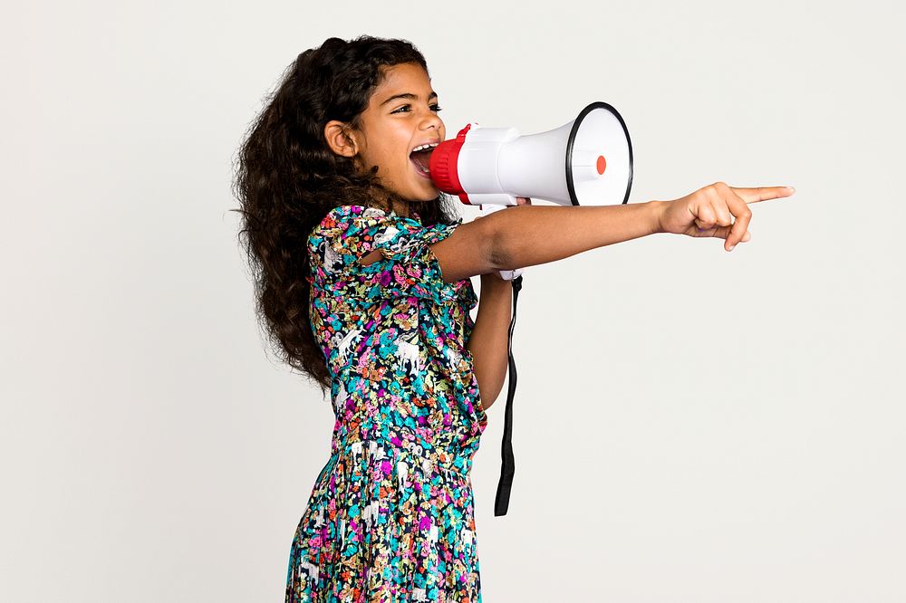 Little girl with megaphone, isolated on off white