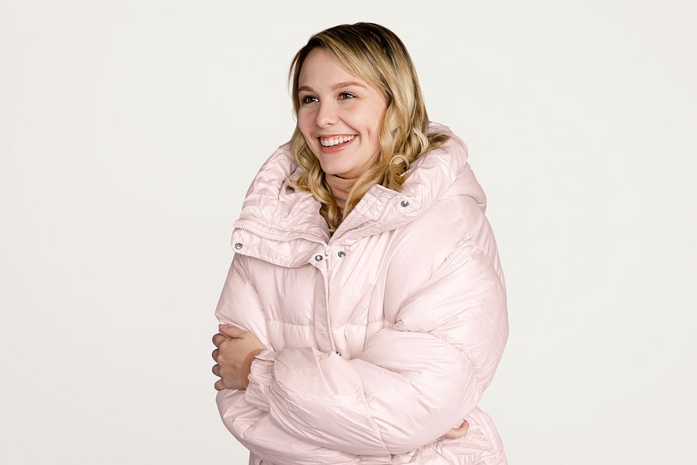 Woman in puffer jacket, isolated on off white