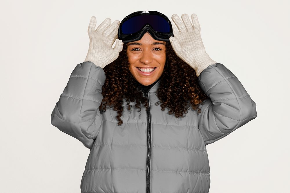 Happy woman with ski goggles, isolated on off white