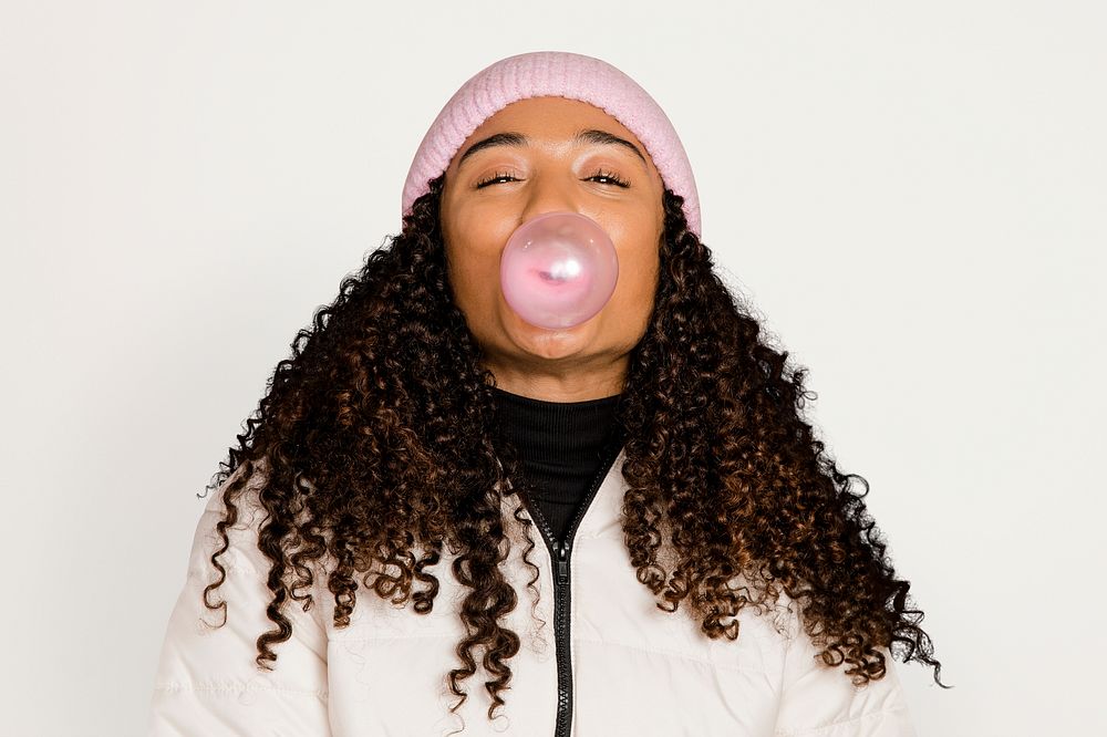 Woman with bubblegum, isolated on off white