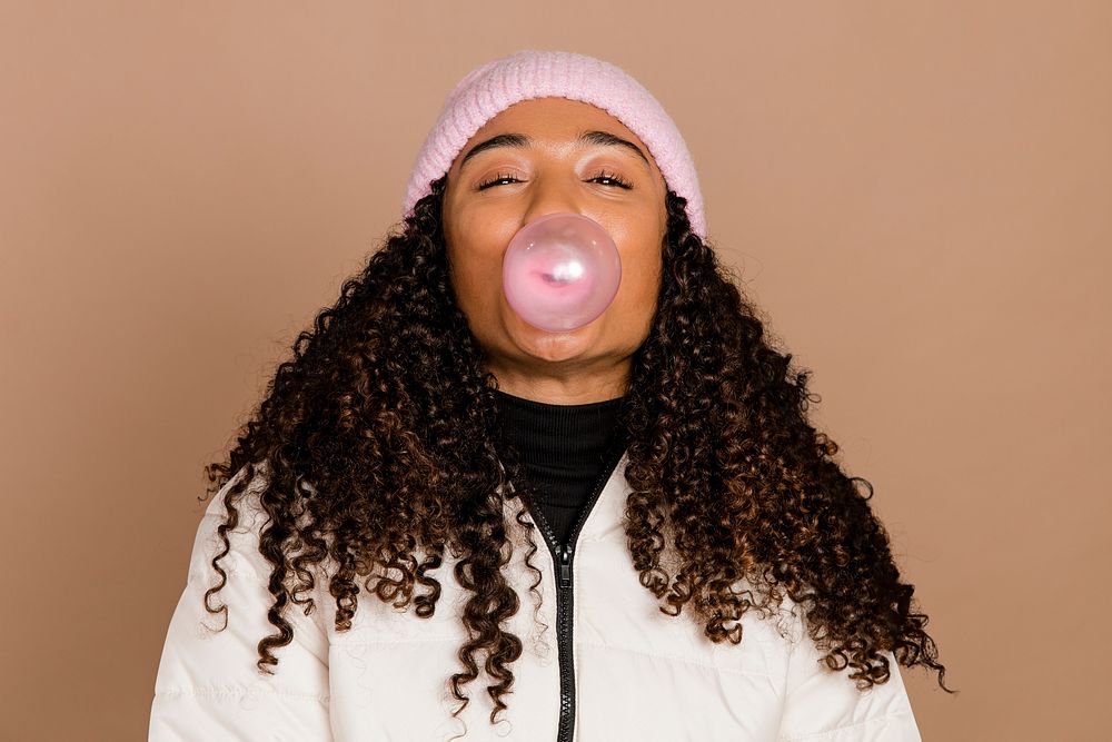 African American woman blowing bubblegum