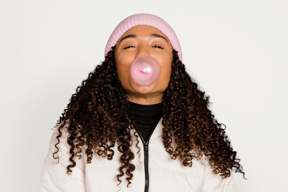 Woman with bubblegum, isolated on off white psd