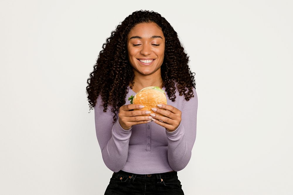 Woman eating burger, junk food psd