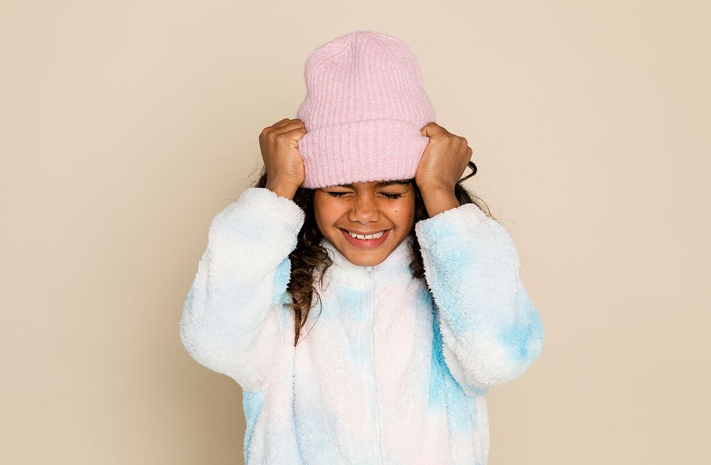 Cute African American girl in pink beanie and winter outfit