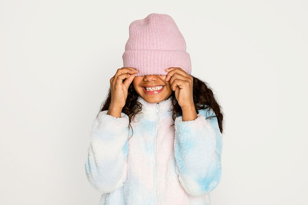 Little girl in winter outfit, isolated on off white psd