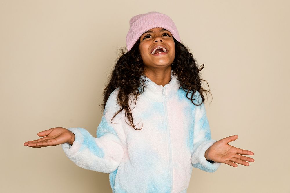 Cute African American girl in pink beanie and winter outfit