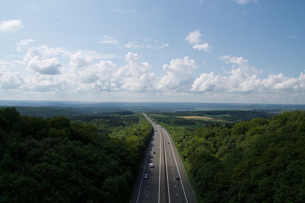 Drone view of freeway through the woods. Original public domain image from Wikimedia Commons