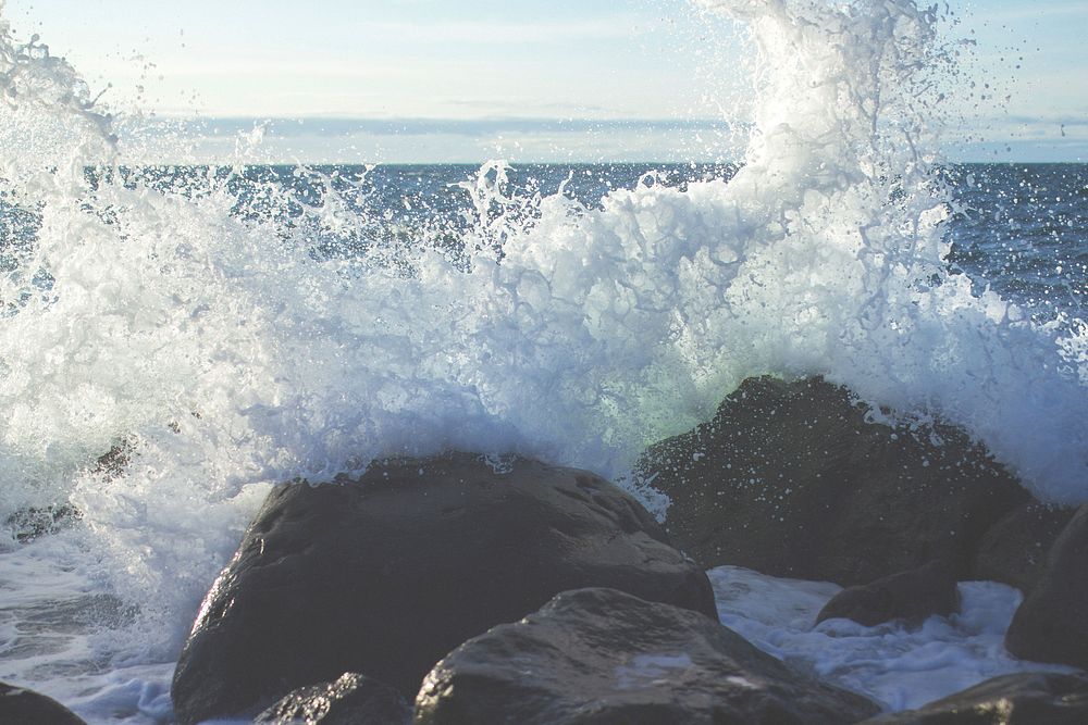 Ocean waves hitting rocks, water splashing. Original public domain image from Wikimedia Commons
