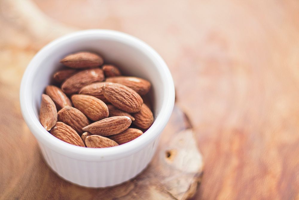 Ramekin of raw almonds for a healthy snack. Original public domain image from Wikimedia Commons