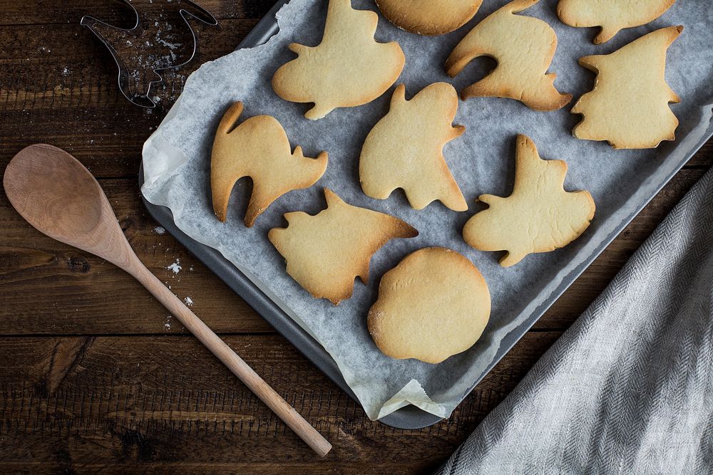 Baked cookies in the shape of cats, ghosts and witches. Original public domain image from Wikimedia Commons