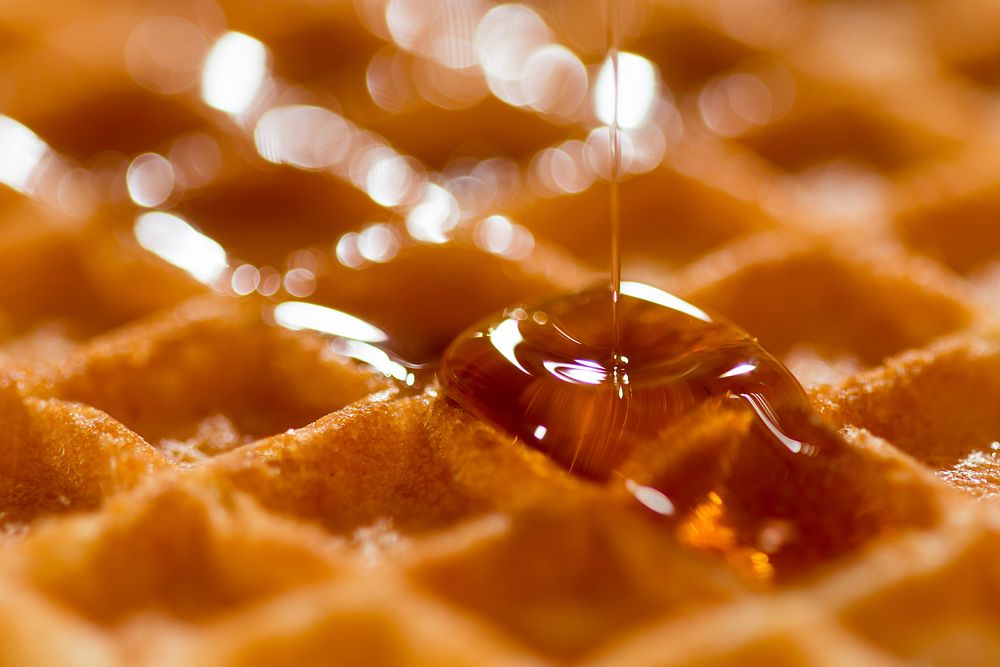 Close-up of maple syrup dripping on a waffle. Original public domain image from Wikimedia Commons