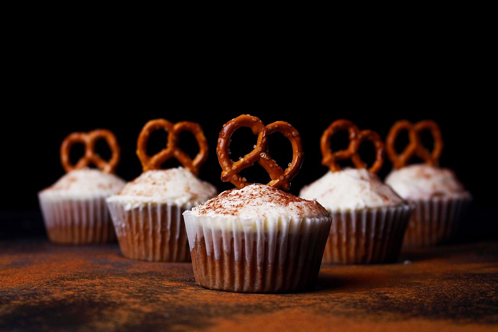 Homemade cupcakes topped with cinnamon and pretzels. Original public domain image from Wikimedia Commons