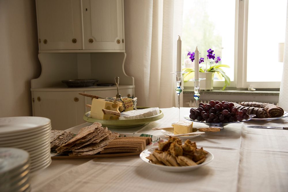 Charcuterie spread with grapes, bread, crackers, and cheese. Original public domain image from Wikimedia Commons