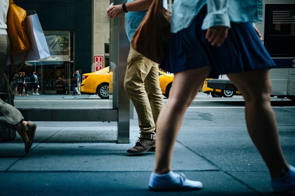 A low shot of people's legs on a sidewalk on Fifth Avenue. Original public domain image from Wikimedia Commons